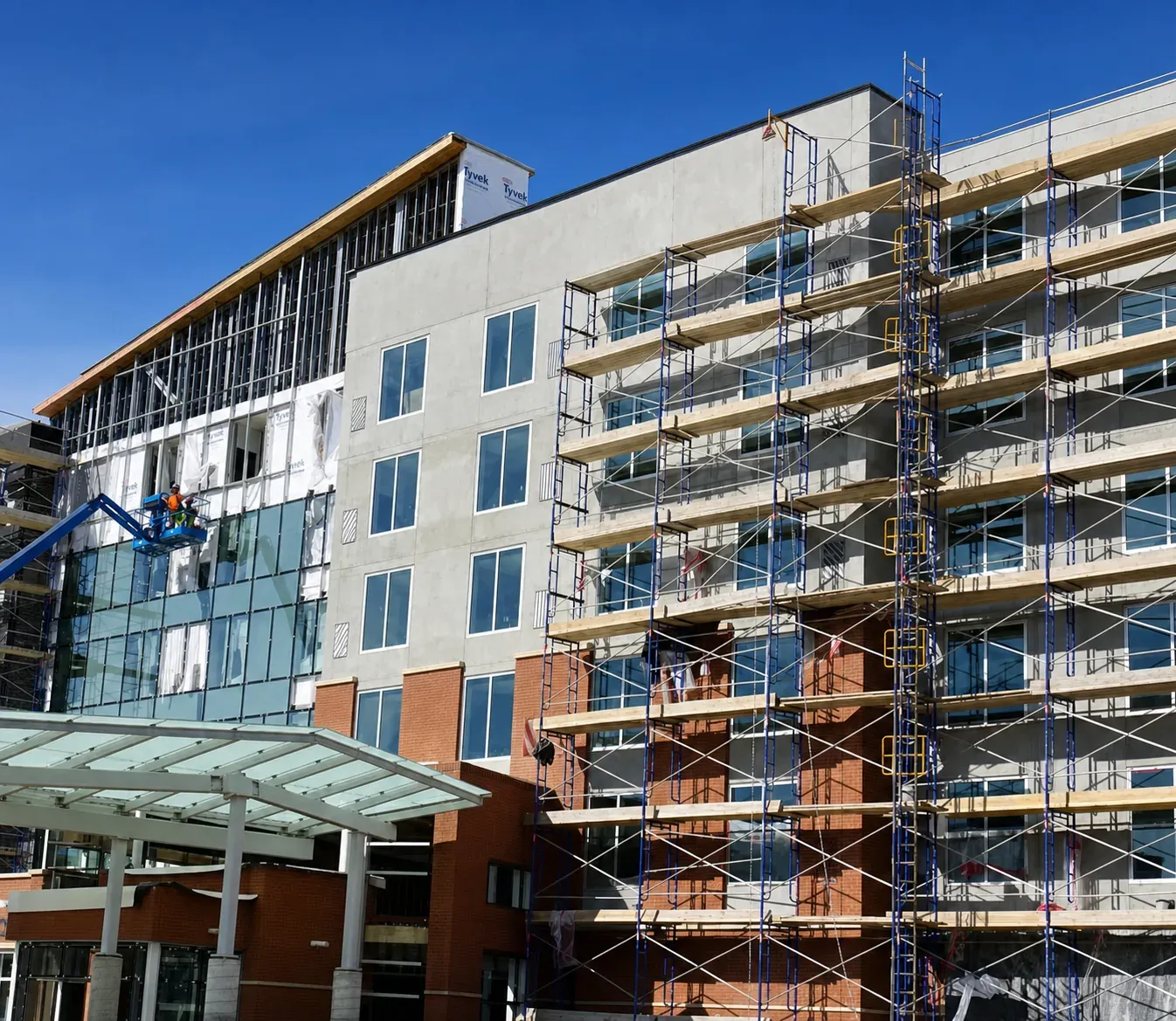 Multi-story building fully scaffolded for exterior envelope work